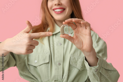 Young woman pointing at hea...