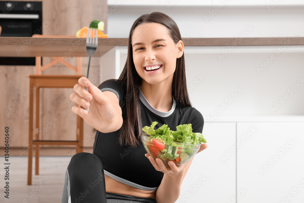 Beautiful young happy woman with bowl of fresh salad sitting in kitchen at home. Weight loss concept Beautiful young happy woman with bowl of fresh salad sitting in kitchen at home. Weight loss concept