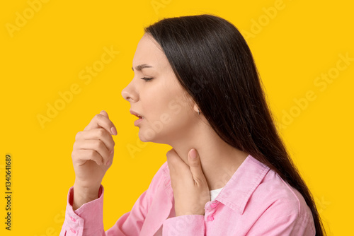 Young woman coughing and ho...