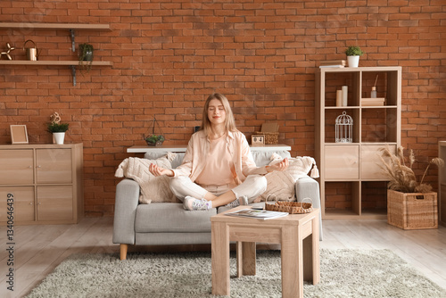 Young woman meditating on s...