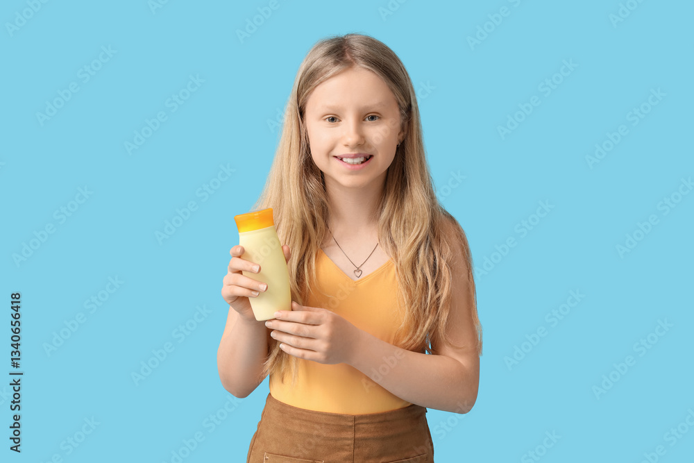 Beautiful girl with bottle of sunscreen cream on blue background Beautiful girl with bottle of sunscreen cream on blue background