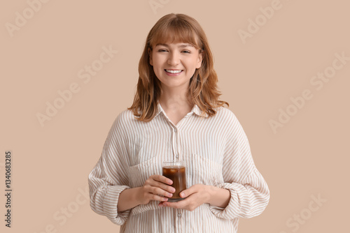 Smiling young woman holding...