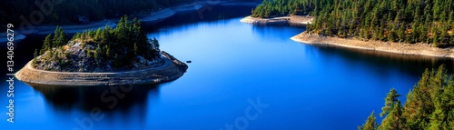 Lake Surrounded by Dense Evergreen Forest Landscape in Serene Natural Environment Scenery
