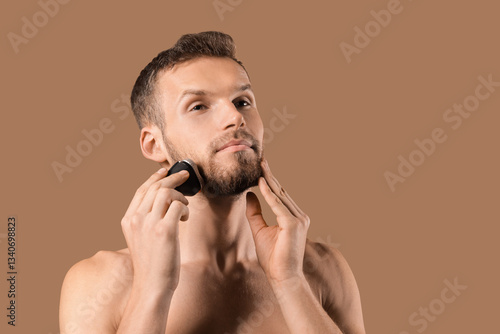 Handsome young man trimming...