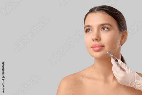 Young woman receiving fille...