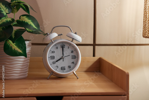 White alarm clock on wooden...
