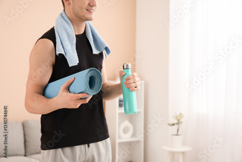 Sporty young man with bottl...