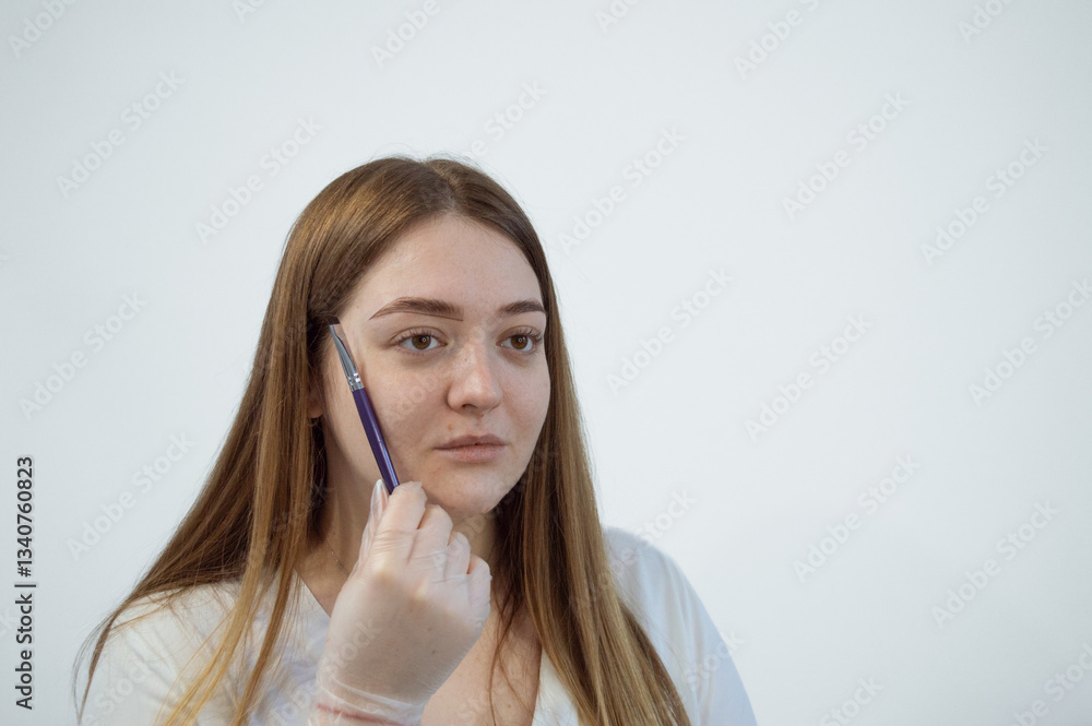 Female Eyebrow correction, the master tints the eyebrows. Beauty industry. Close-up. Using a purple brush. Contouring. Self-care, self-grooming. Female Eyebrow correction, the master tints the eyebrows. Beauty industry. Close-up. Using a purple brush. Contouring. Self-care, self-grooming.