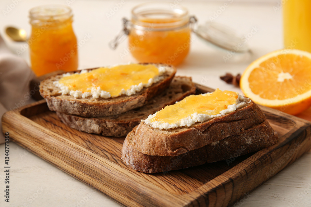 Tasty sandwiches with butter and sweet orange jam on board, closeup Tasty sandwiches with butter and sweet orange jam on board, closeup