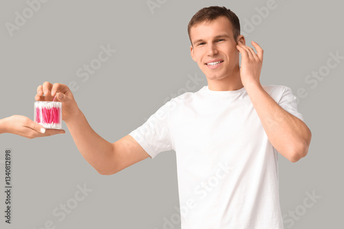 Young man and hand with cot...