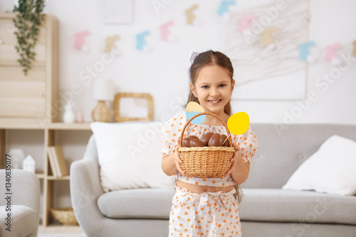 Cute little girl holding wi...