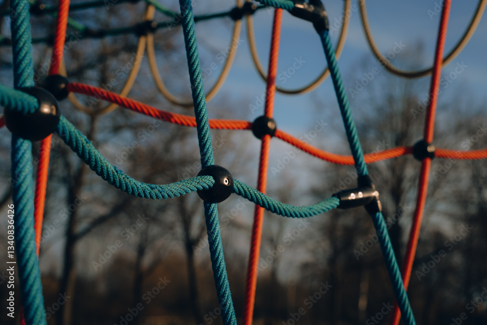 Brightly colored playground climbing structure in a park during a sunny day