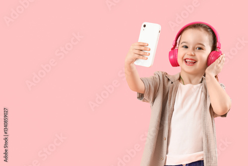 Cute little girl in headpho...