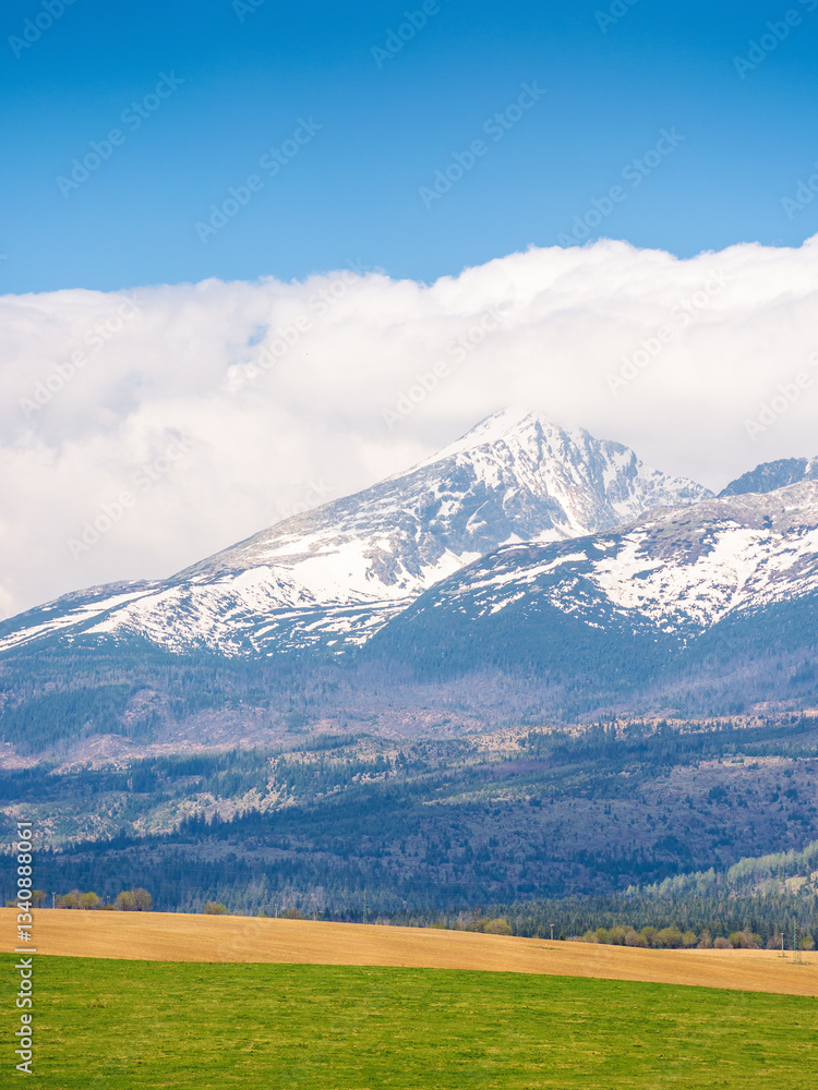 tatra mountain landscape in spring. scenic nature of europe for travel. slovakia countryside scenery with snow on the peak. beautiful alpine view with blue sky and cloud for tourism