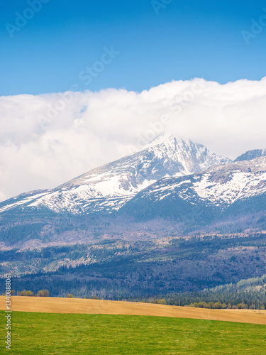 Obraz na płótnie tatra mountain landscape in spring. scenic nature of europe for travel. slovakia countryside scenery with snow on the peak. beautiful alpine view with blue sky and cloud for tourism w salonie