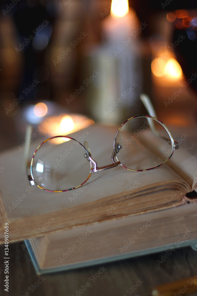 Books, lit candles, red wine, snacks and various deocration on the table. Dark academia or Halloween concept. Selective focus.