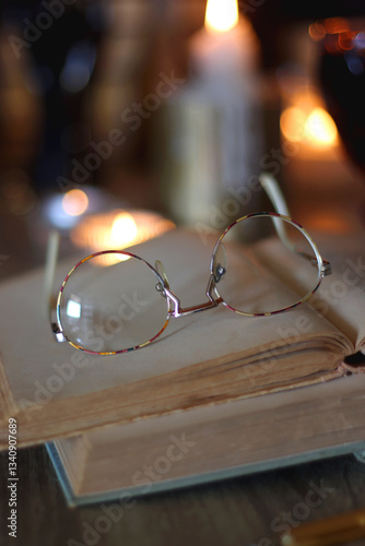 Obraz na płótnie Books, lit candles, red wine, snacks and various deocration on the table. Dark academia or Halloween concept. Selective focus. w salonie