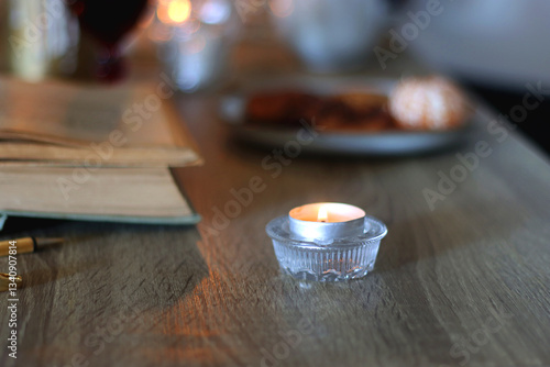 Obraz na płótnie Books, lit candles, red wine, snacks and various deocration on the table. Dark academia or Halloween concept. Selective focus. w salonie