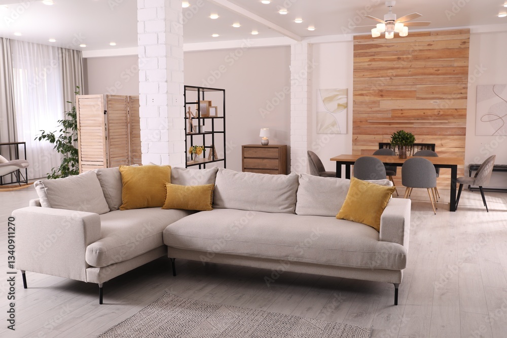 Fototapeta premium Stylish living room interior with comfortable sofa and wooden table