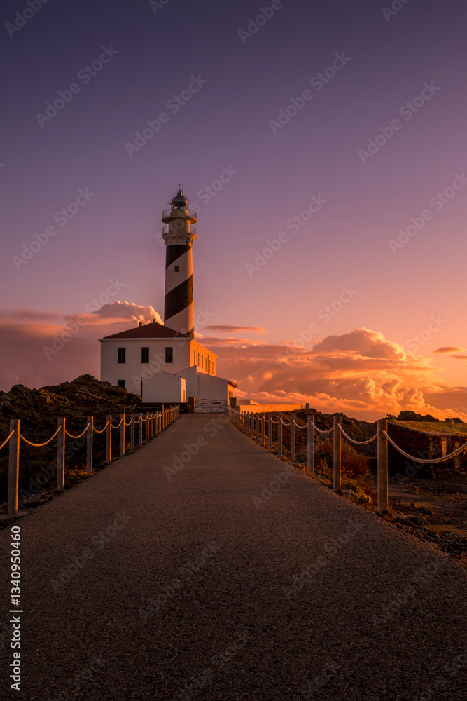 Cape Favaritx Lighthouse in Minorca at dawn, Spain, offering serene coastal views. Sunrise at the Lighthouse on the northeastern coast of Menorca in the Balearic Islands. Biosphere Reserve.
