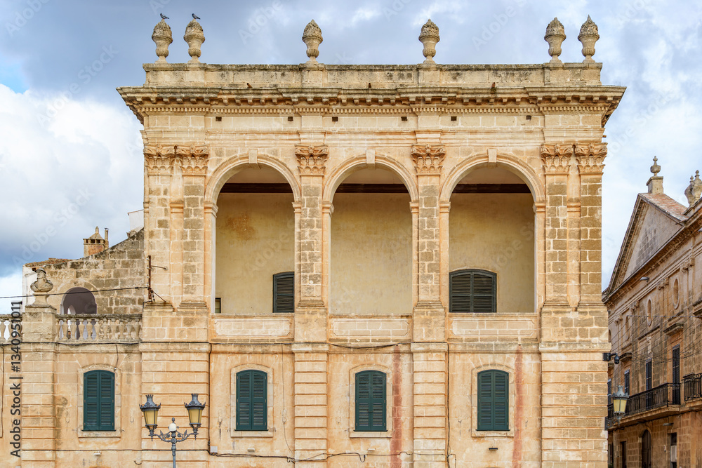 Capture the grandeur of Palace Torresaura in Ciutadella, Menorca. This architectural gem features a historic facade, arched windows, and Balearic elegance. Travel, culture, architecture themes