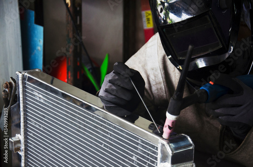 Thai people use electricity welding for fix and solder radiator of car