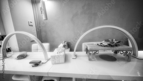 UV nail lamp curing gel polish in a professional manicure session at a beauty salon