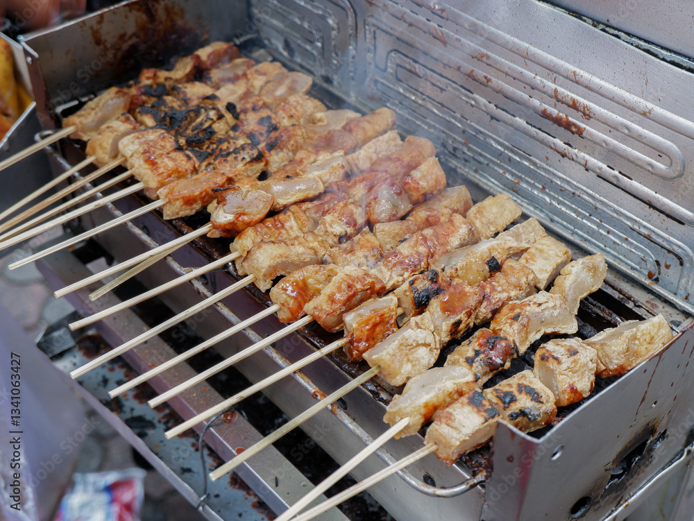 grilled tofu skewered with bamboo. Tahu bakar grilled tofu skewered with bamboo. Tahu bakar