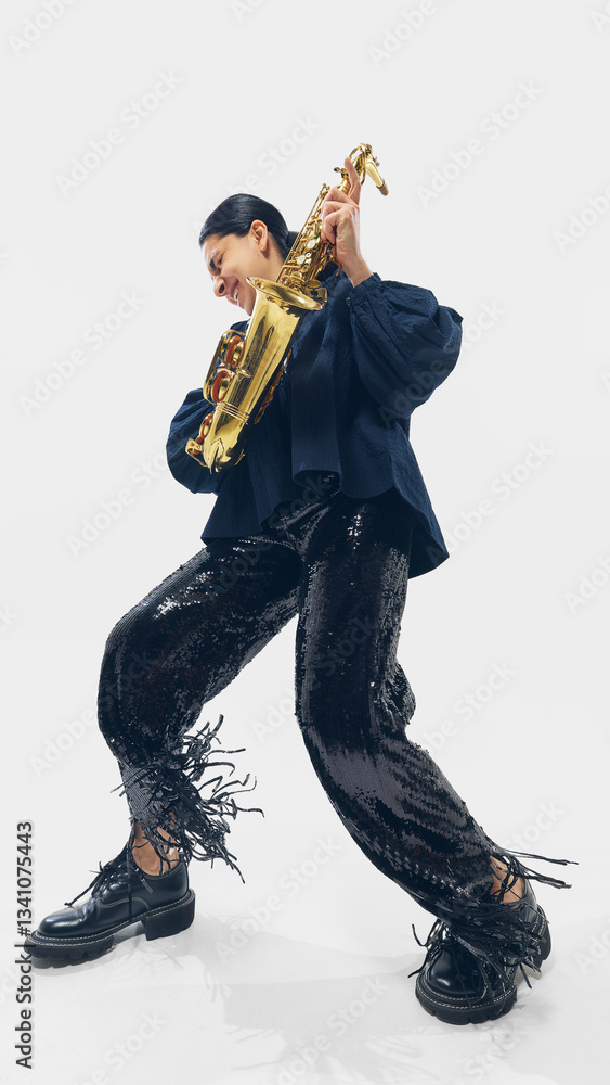 Naklejka premium Woman in black outfit passionately performing, playing saxophone, bending into rhythm with expressive energy on white background. Concept of music, festival, art, performance, jazz, instruments.