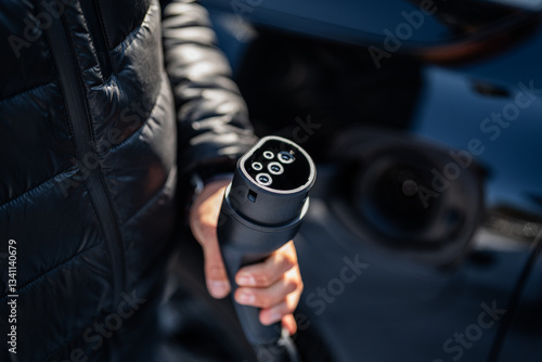 Obraz na płótnie plug into socket - electric car - dark background - training in using a charger types of plugs and power adapters w salonie