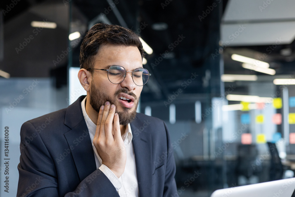 Man suffering from toothache at workplace inside office. Businessman working at workplace sick has gum inflammation. Man suffering from toothache at workplace inside office. Businessman working at workplace sick has gum inflammation.