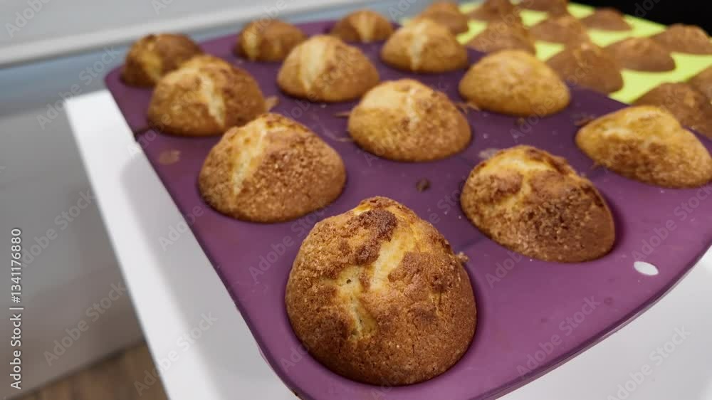 A tray of muffins sits on a counter A tray of muffins sits on a counter