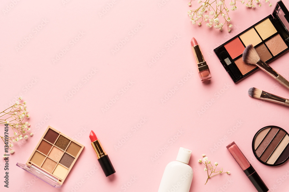 Makeup products flat lay background on pink. Eyeshadow, highlighter, cream, lipsticks and cosmetic brushes.