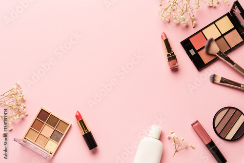 Obraz na płótnie Makeup products flat lay background on pink. Eyeshadow, highlighter, cream, lipsticks and cosmetic brushes. w salonie