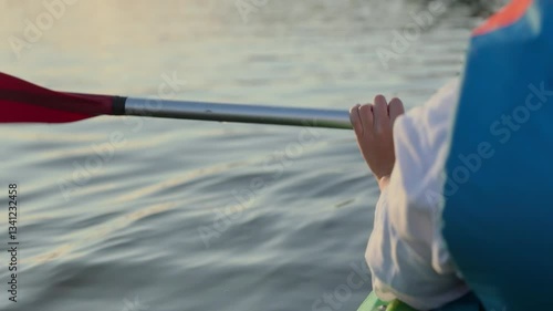 Close-up shot of woman holding a  kayak paddle