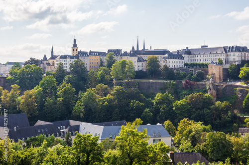 View over the old town of Luxembourg City, Luxembourg, with the steeple of Saint Michael's church and the spires of Notre-Dame cathedral, overlooking the roofs of the Pfaffenthal nursing home.