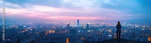 Woman enjoying breathtaking cityscape view at night from rooftop with illuminated buildings and urban lights below