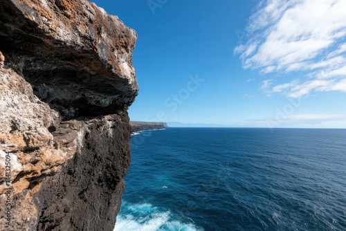 Wallpaper Mural A breathtaking view of rugged cliffs meeting the vast ocean. The sharp contrast between the rock face and deep blue water evokes a sense of adventure and beauty in nature. Torontodigital.ca