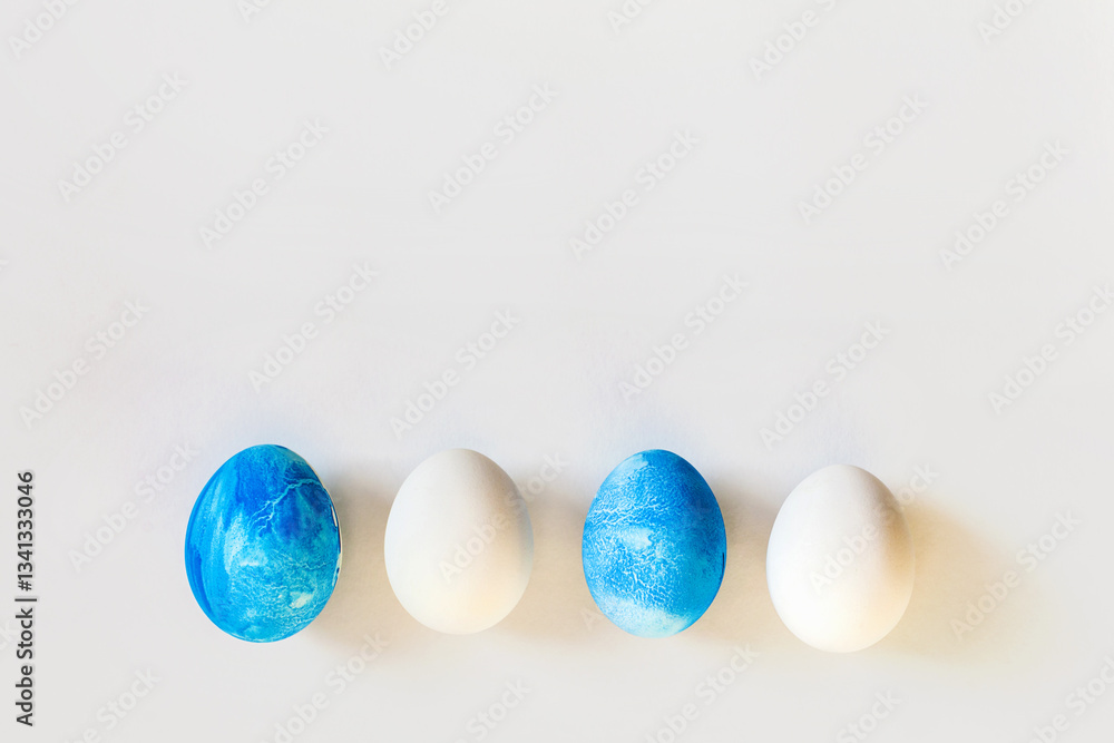 Easter frame with blue and white color eggs isolated on gray background. Stylish trendy minimal set or composition with natural painted egg. Flat lay, top view, place for text. Happy egg hunt concept Easter frame with blue and white color eggs isolated on gray background. Stylish trendy minimal set or composition with natural painted egg. Flat lay, top view, place for text. Happy egg hunt concept
