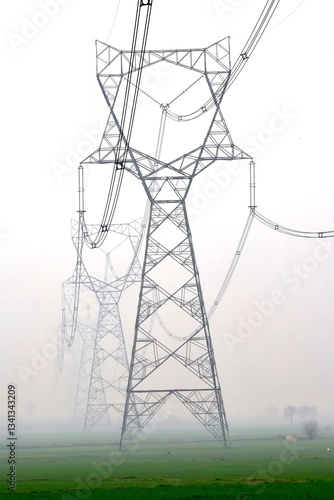 Electricity transmission towers in fog. High power. Energy supply, distribution of energy, high voltage supply. 2024.