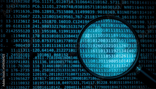 Digital data magnified through lens, showcasing binary code and technology