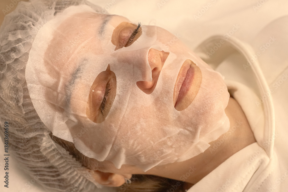 Fabric cosmetic mask. The secret of beauty, youth and radiant skin. Anti-aging skin care 40+. Cosmetic procedure. Skin hydration. Facial nutrition. Women's beauty. Beauty treatment. Beauty salon. Fabric cosmetic mask. The secret of beauty, youth and radiant skin. Anti-aging skin care 40+. Cosmetic procedure. Skin hydration. Facial nutrition. Women's beauty. Beauty treatment. Beauty salon.