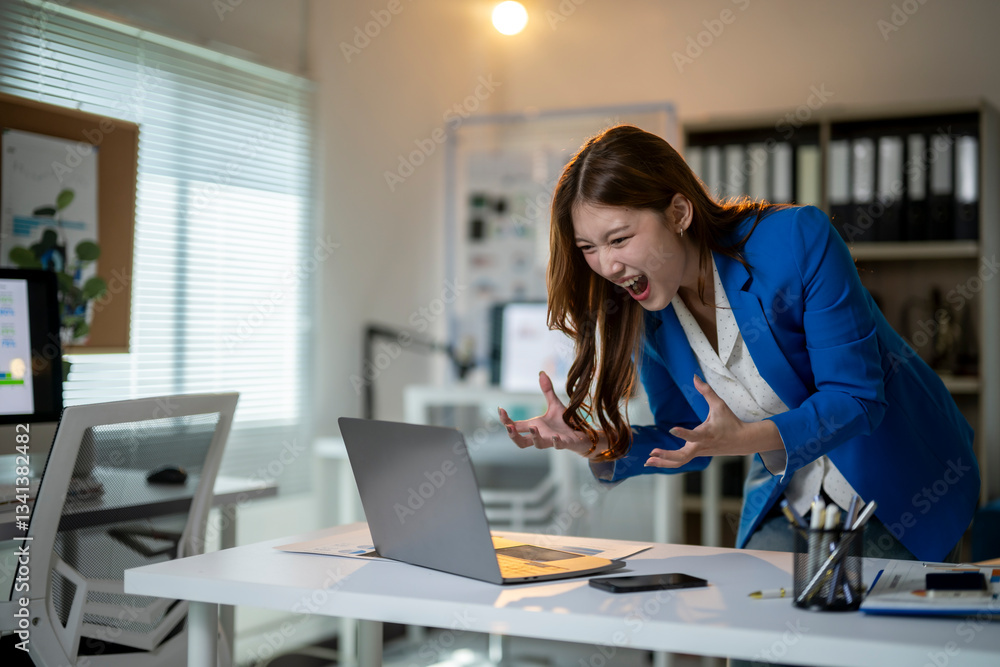 A woman is sitting at a desk with a laptop and a cell phone A woman is sitting at a desk with a laptop and a cell phone