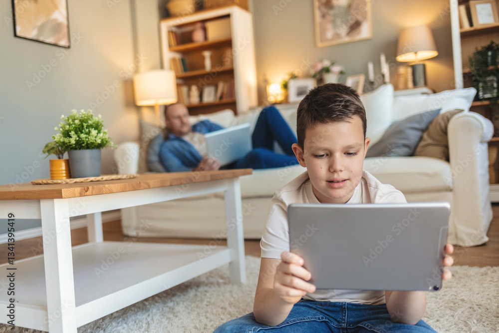 Tablet and child learning on carpet in living room for holiday, digital education and kindergarten knowledge with boy portrait. Family relax with technology on lounge floor. Tablet and child learning on carpet in living room for holiday, digital education and kindergarten knowledge with boy portrait. Family relax with technology on lounge floor.