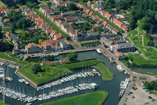 Exploring the vibrant architecture and scenic marina of Willemstad, a charming coastal town in the Netherlands amidst lush greenery