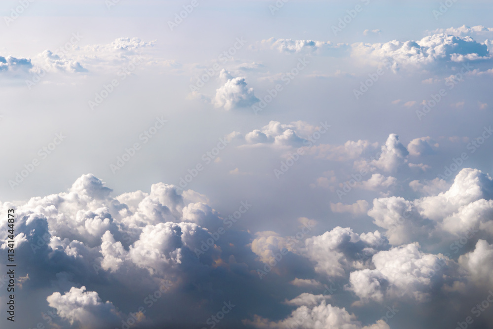 Obraz premium The background is textured dramatic blue-white clouds in the sky, the view from the window of a samsolet. Fantastically beautiful natural background, a peaceful and peaceful scene of real nature.