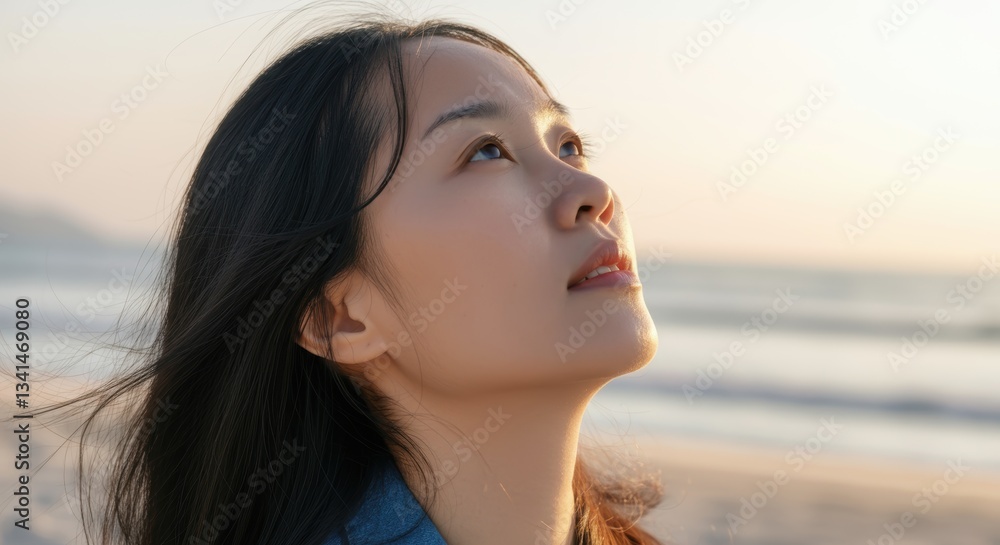 Young asian female gazing at peaceful beach sunset Young asian female gazing at peaceful beach sunset