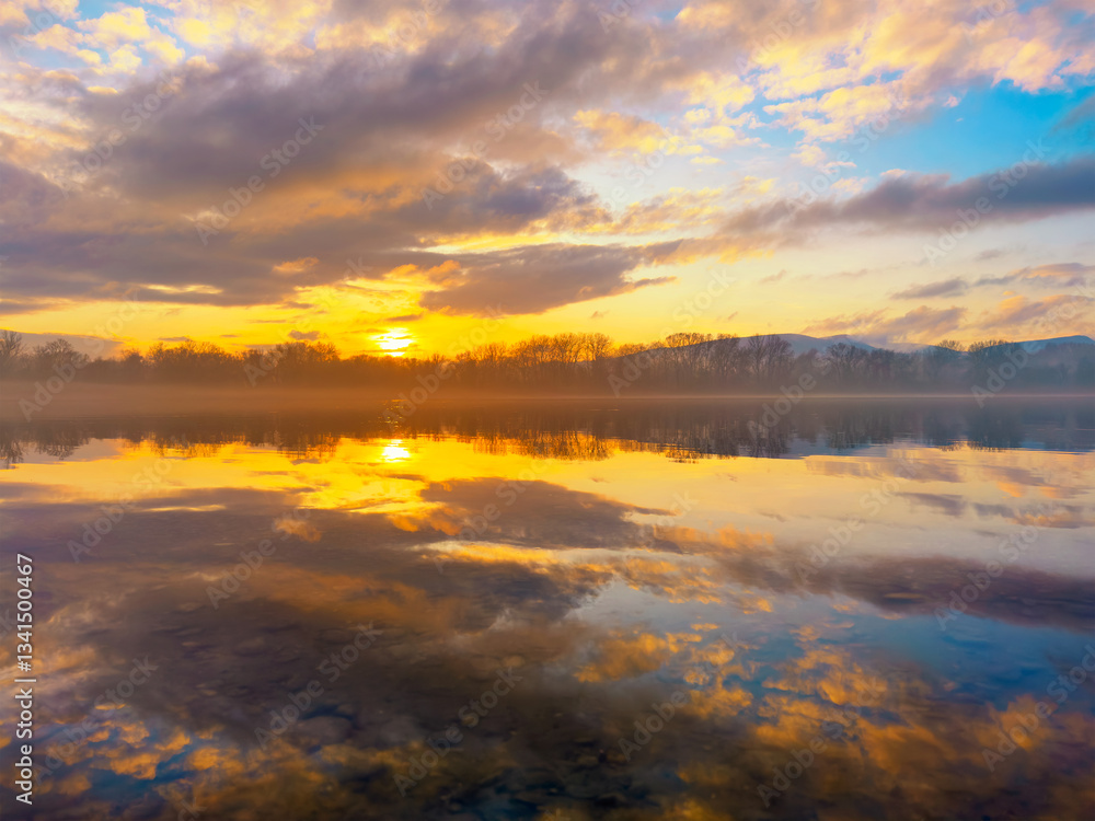 beutiful colorful sunset over the river with cloud reflection