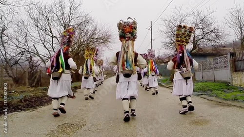 Kukeri performers run through Kalipetrovo, Bulgaria, wearing traditional masks and costumes. This ritual dance, part of Bulgarian folklore, is believed to chase away evil spirits.