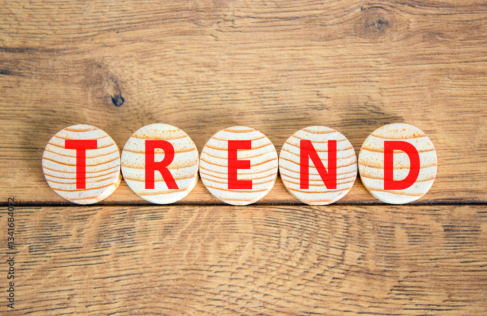Fototapeta premium Trend and trending symbol. Concept word Trend on beautiful wooden circles. Beautiful wooden table wooden background. Business lifestyle trend and trending concept. Copy space.